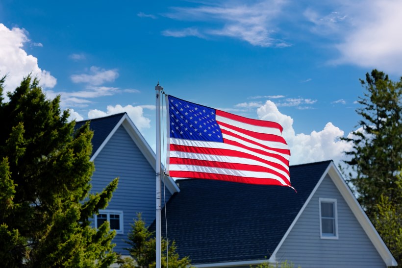Military flag in front of new home 